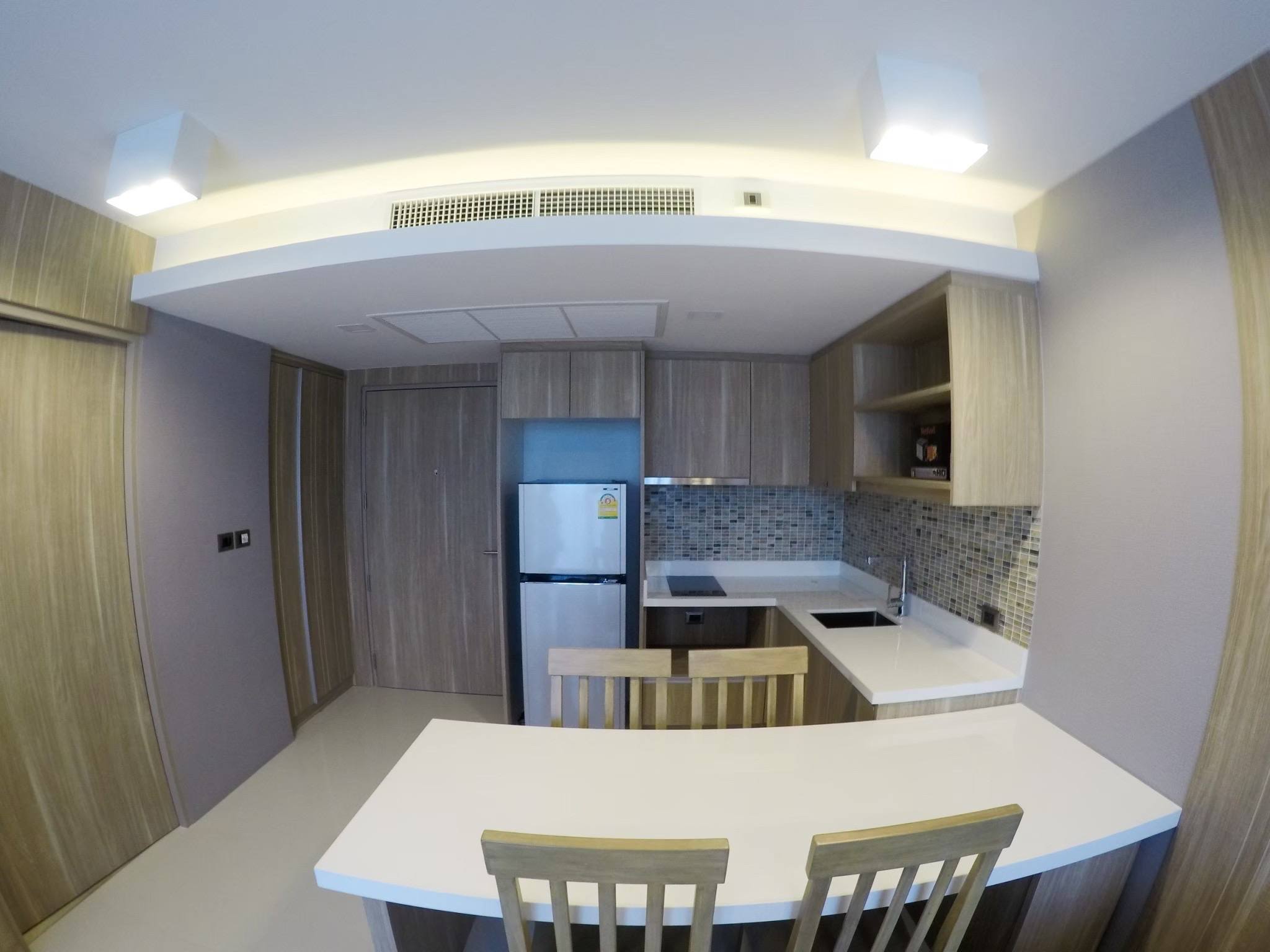 Modern fitted kitchen and dining counter in The Pine Hua Hin one-bedroom condominium