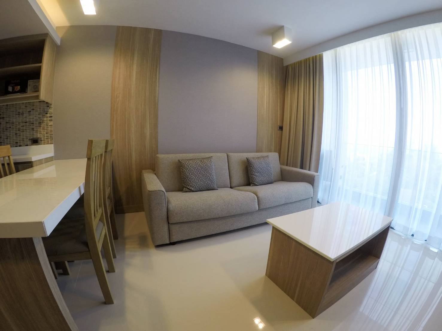 Bright furnished living room with sofa and balcony light at The Pine Hua Hin