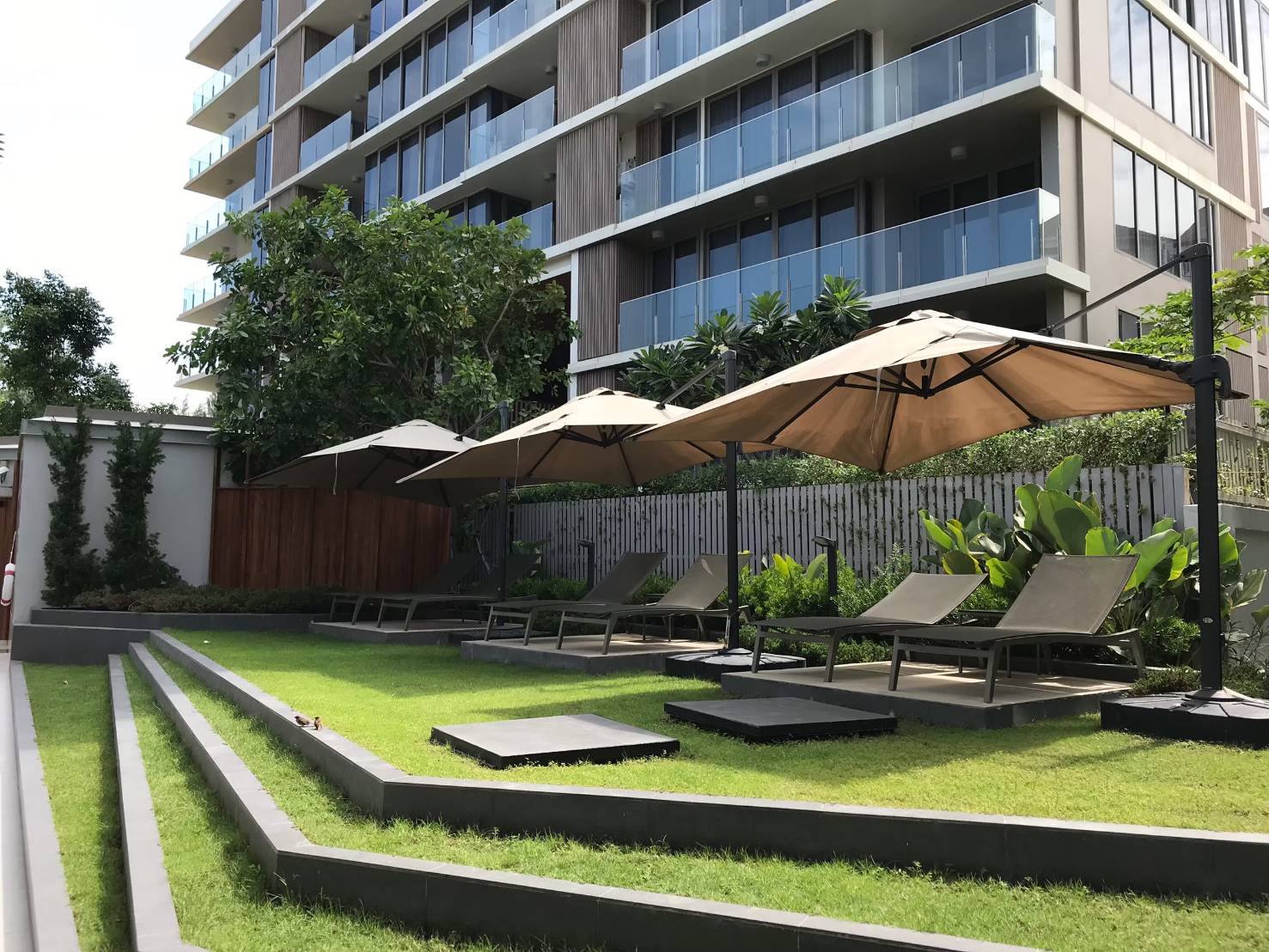 Landscaped tropical garden and condominium building at The Pine Hua Hin