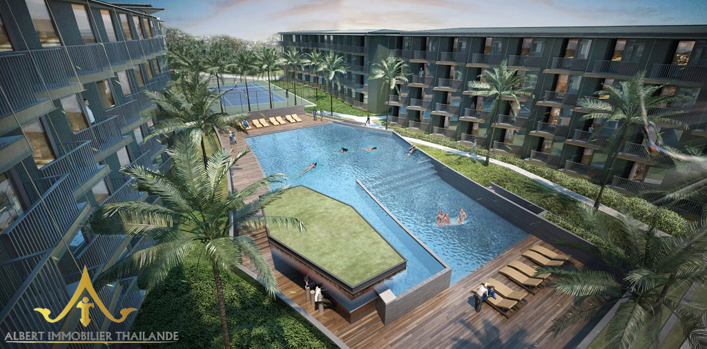 Large resort-style swimming pool surrounded by Wing Samui condominium buildings in Bophut, Koh Samui